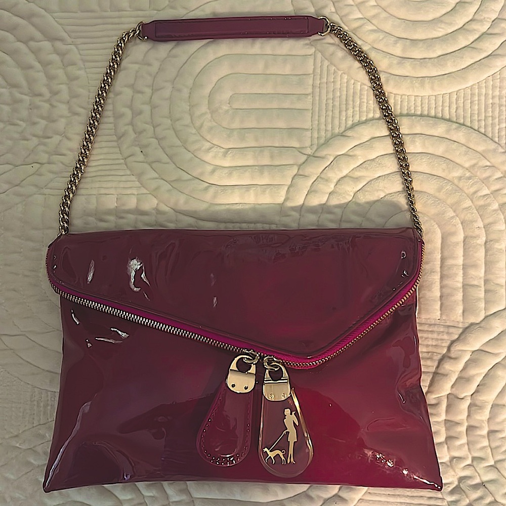 Henri  Bendel Purple Pink Patent Leather clutch . Comes with original dust bag.